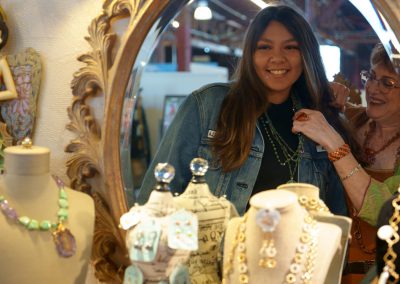 Woman trying on Diva Beads necklace